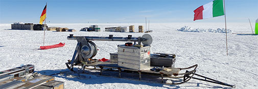 The shallow drill tower assembled on a Nansen sled. When drilling, the tower is turned into vertical position, and the drill, which is about 4 meters long, is lowered into an inclined trench. Two persons can lift all parts of the drill, and the whole setup fits in the back of a Twin Otter airplane or can be dragged behind a skidoo.